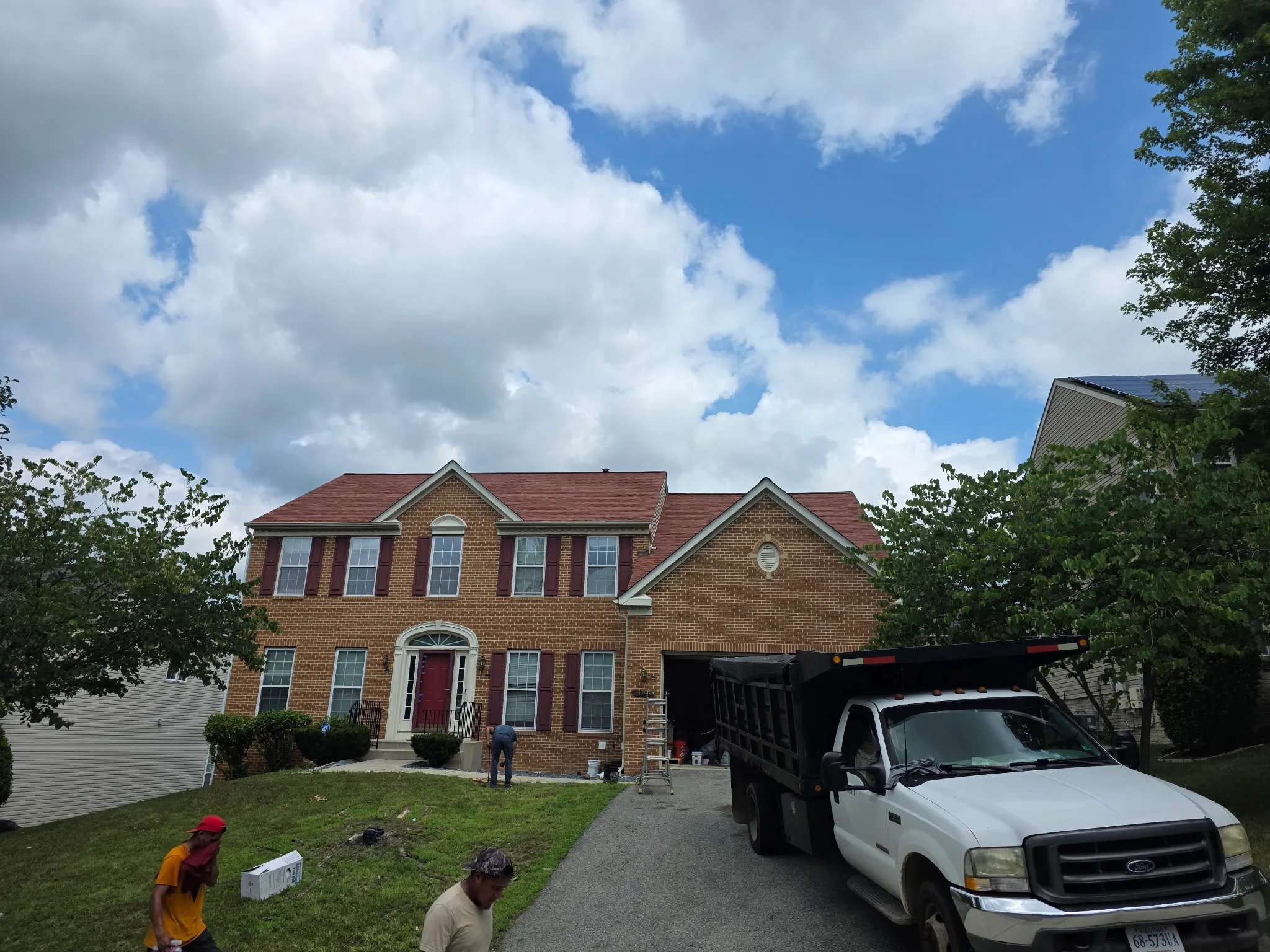 After: residential brick home following roof replacement.