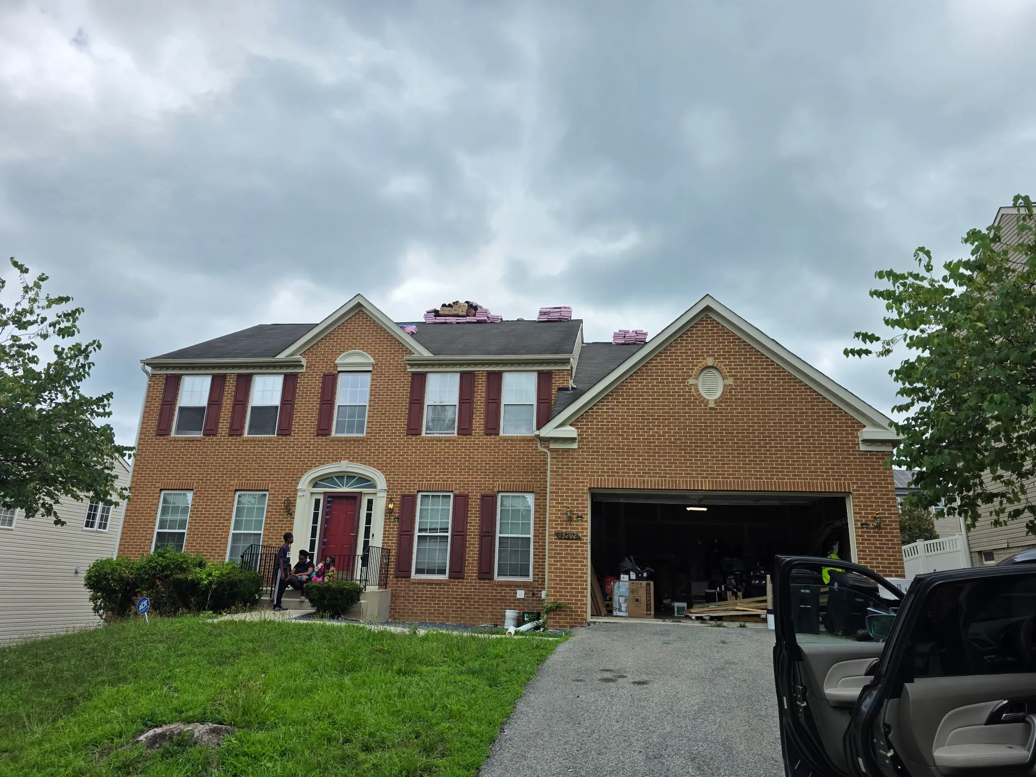 Before: residential brick home prior to roof replacement.