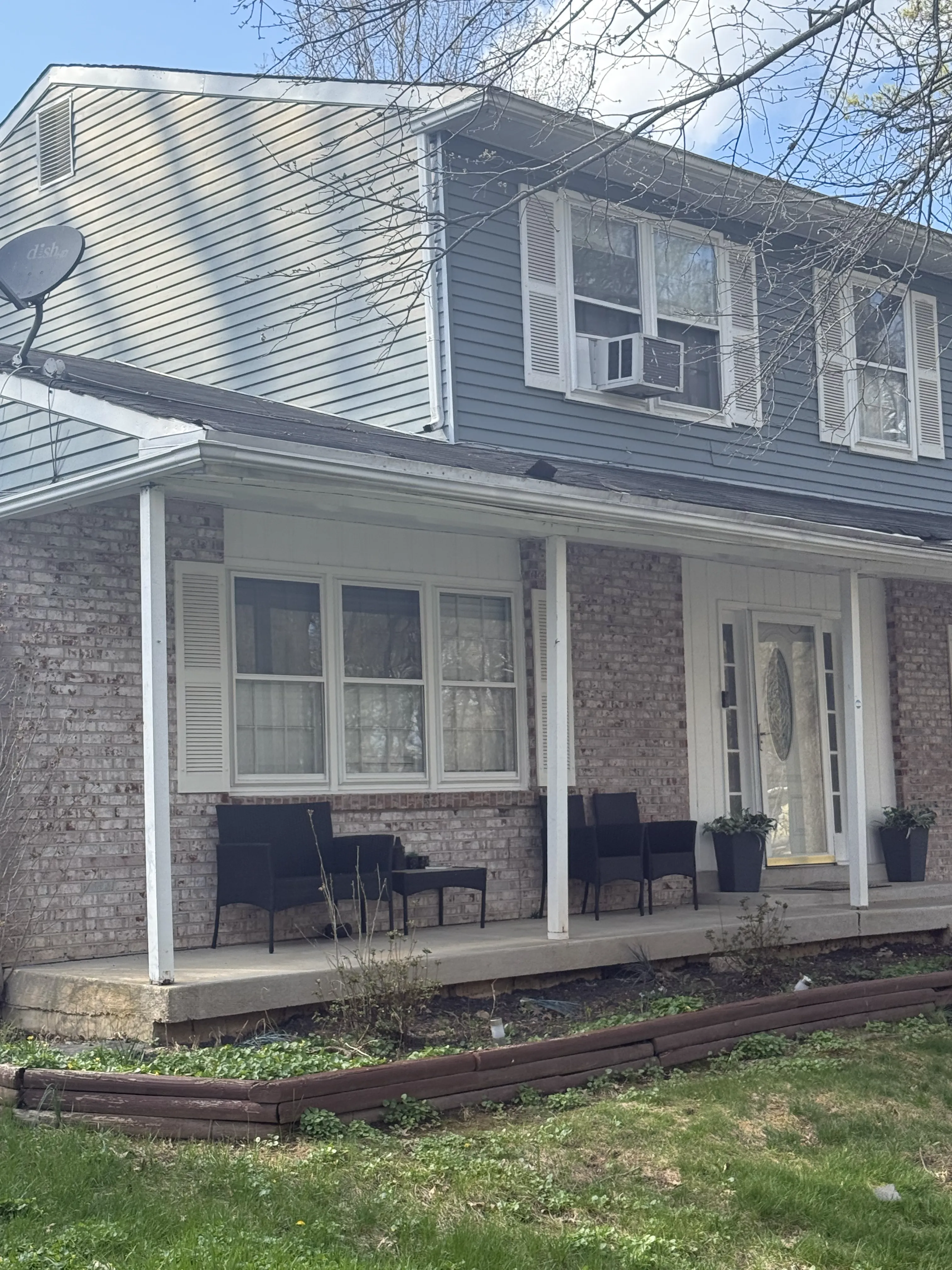 Completed residential roofing project viewed from the front porch.