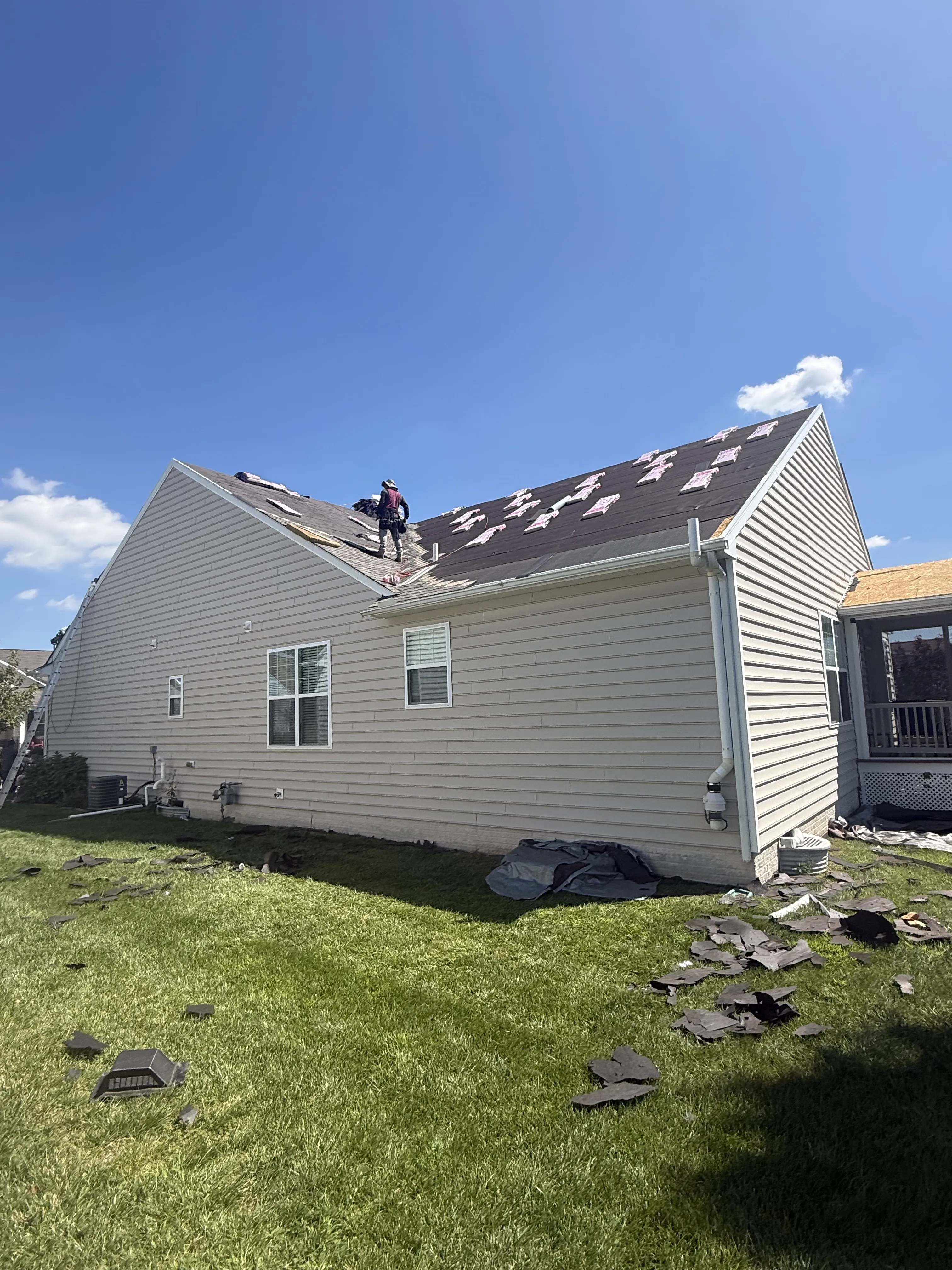 Roofing crew working on a residential roof replacement.